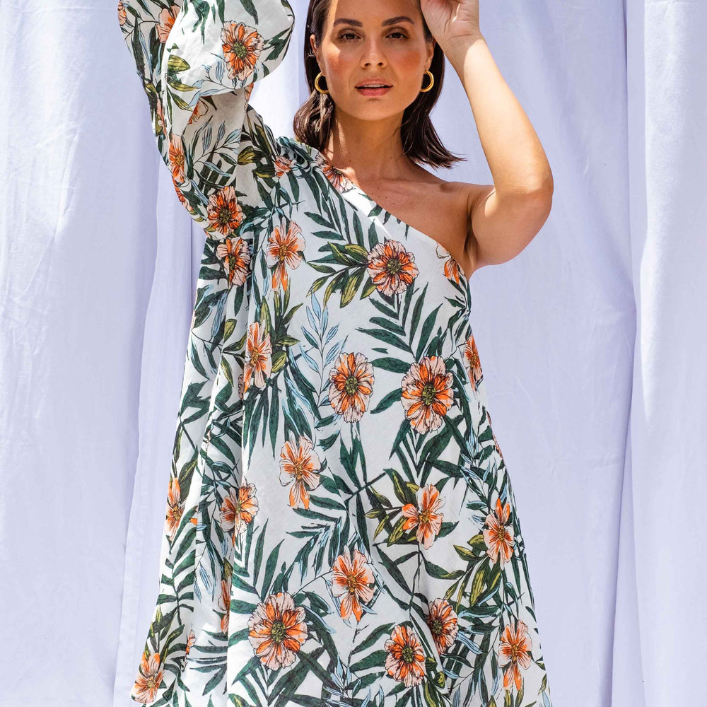 
                      
                        Woman wearing Palm Balloon Sleeve Swing Dress by Isabella Longginou. She has both arms above her head with her hands clasped.
                      
                    