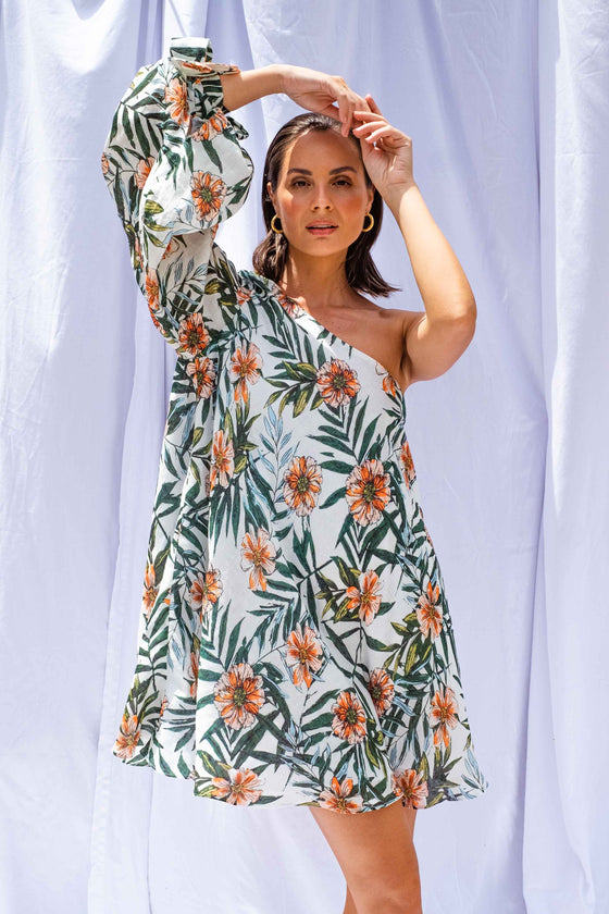 Woman wearing Palm Balloon Sleeve Swing Dress by Isabella Longginou. She has both arms above her head with her hands clasped.