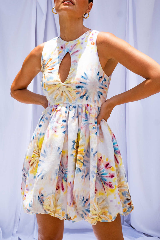 Close up of woman wearing Tie Dye Bubble Mini Dress by Australian designer Isabella Longginou. 
